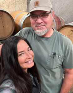 photograph of owners mike and laura wieters of domaine chardonnay int heir barrel room